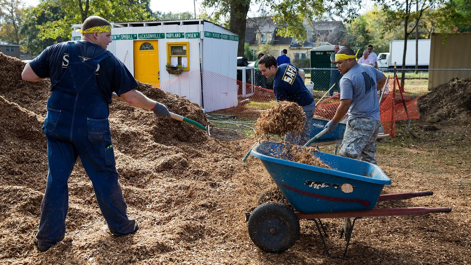 Neighbours and volunteers building a community playground together