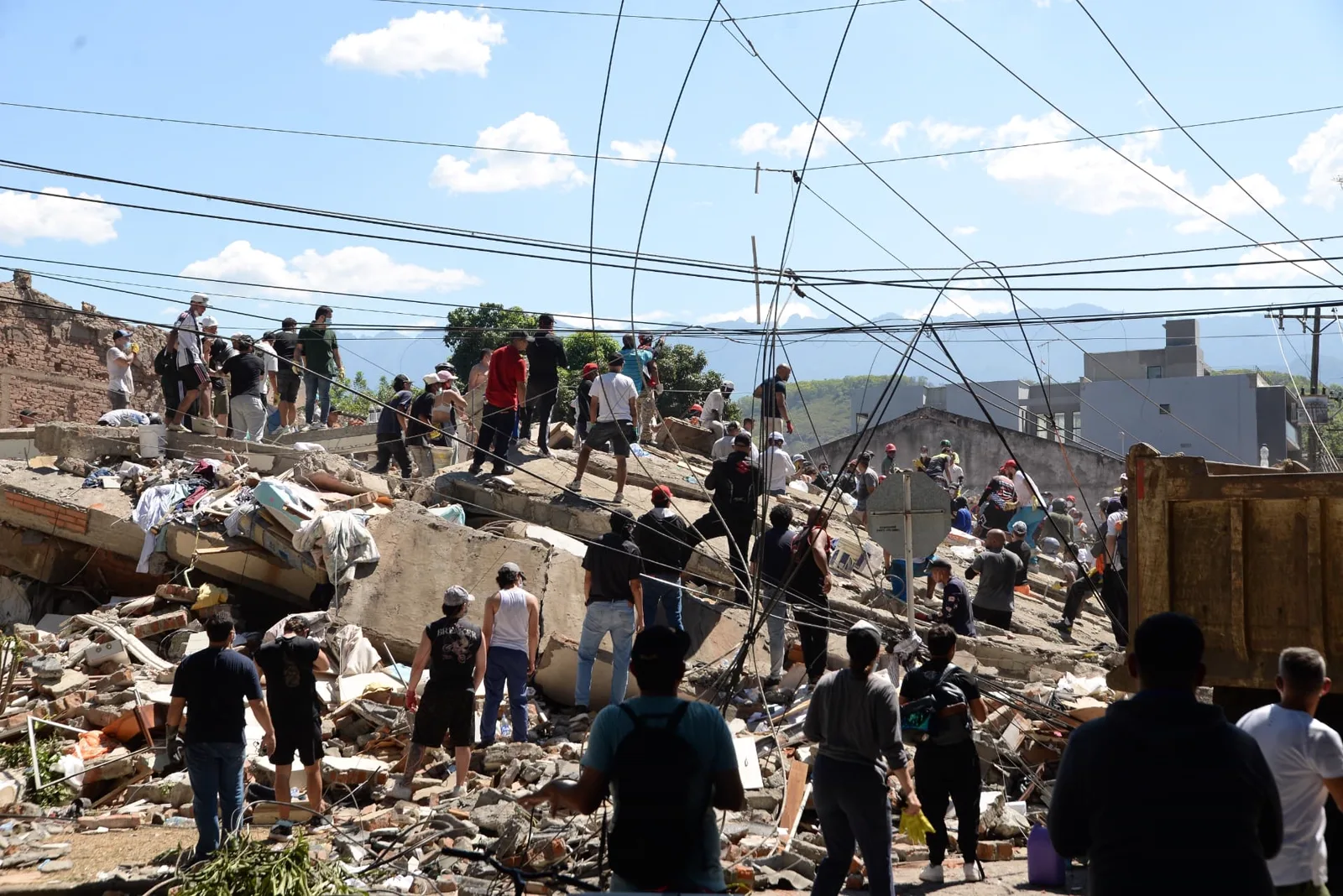 Residents and rescue crews searching collapsed buildings after an earthquake in Colombia