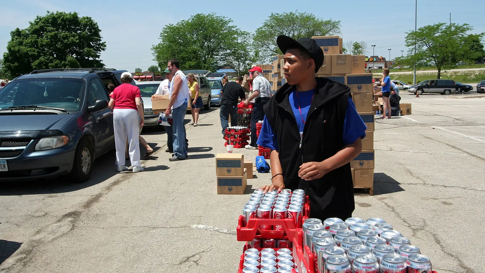 Volunteers unloading and distributing bottled water to families after a disaster